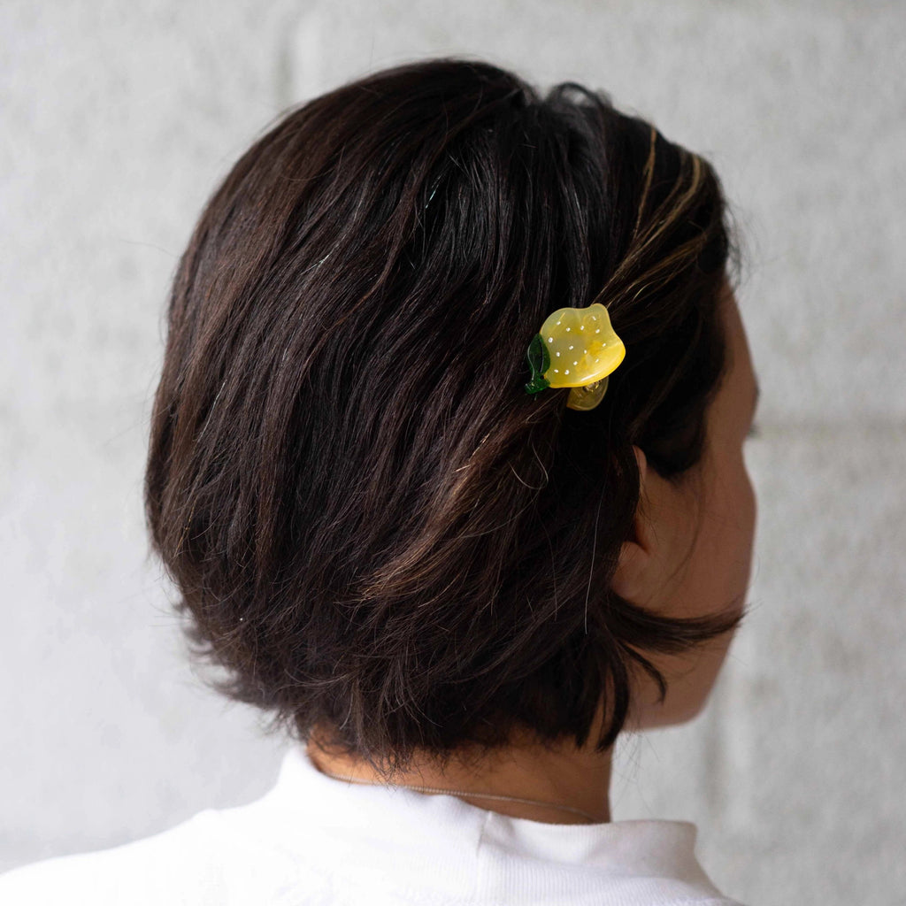 Person wearing Mini Lemon Hair Claw.