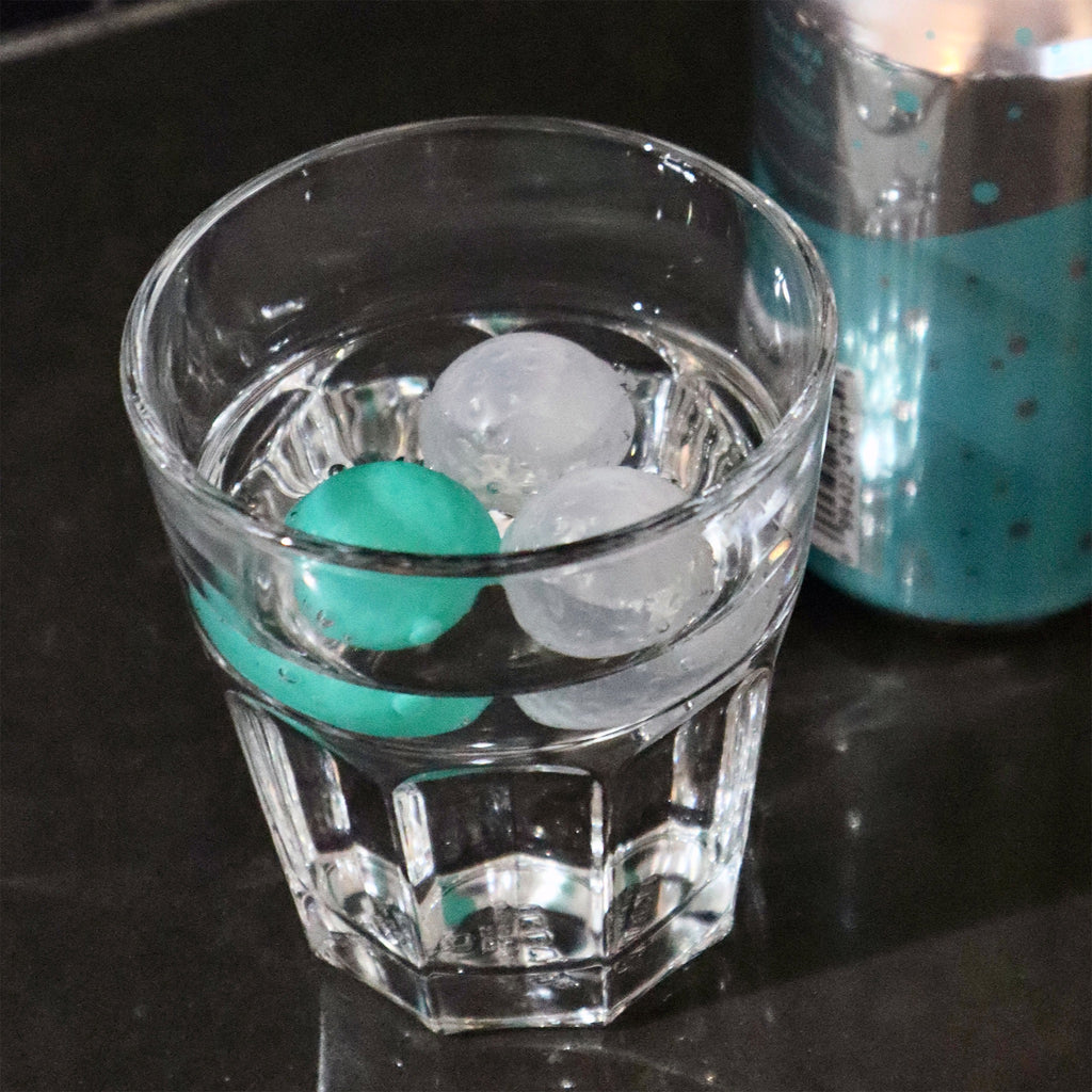 24 Reusable Golf Ball Ice Cubes in glass.