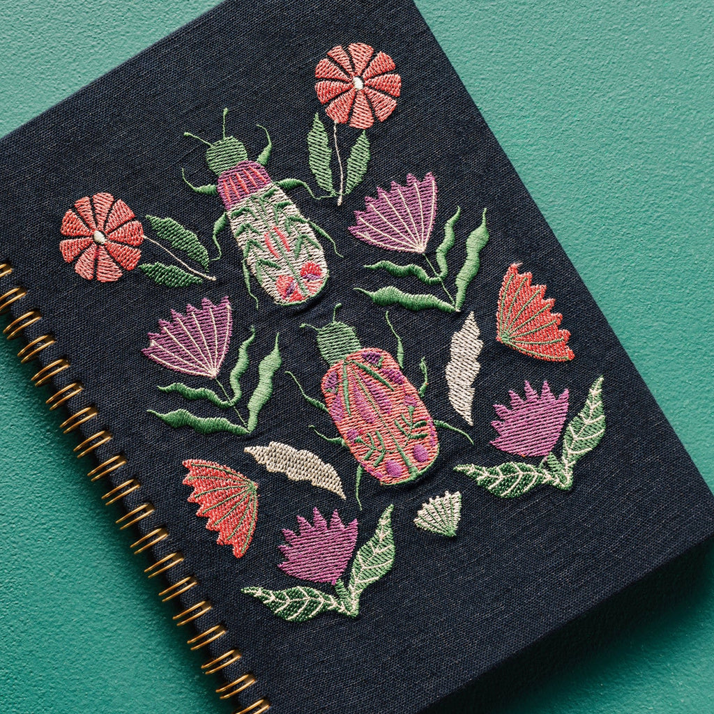 Amulet Ring Bound Embroidered Notebook on surface.