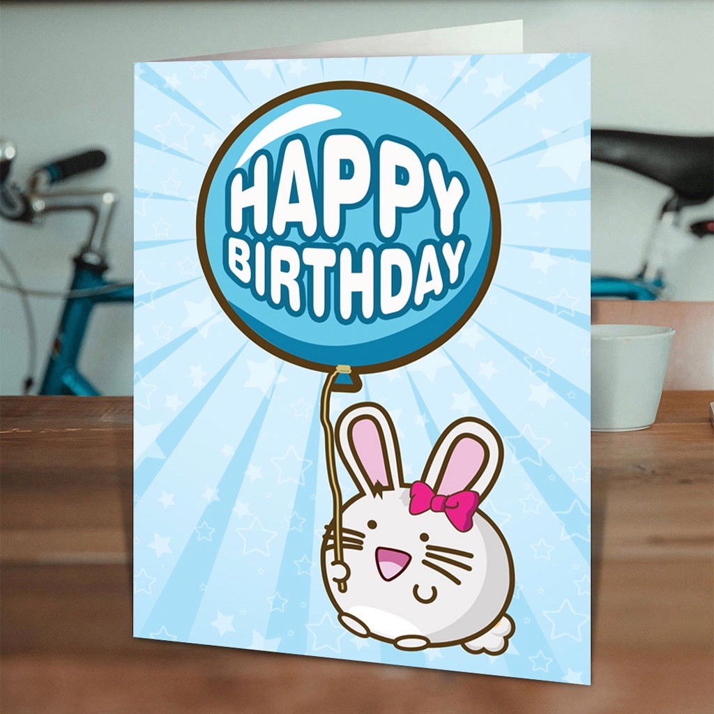 Kawaii Happy Birthday Bunny with Balloon Card on table.