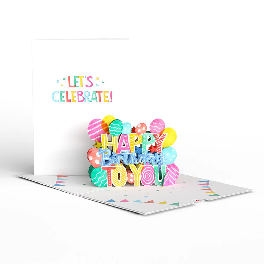 Let's Celebrate Birthday Pop-Up Card on table.