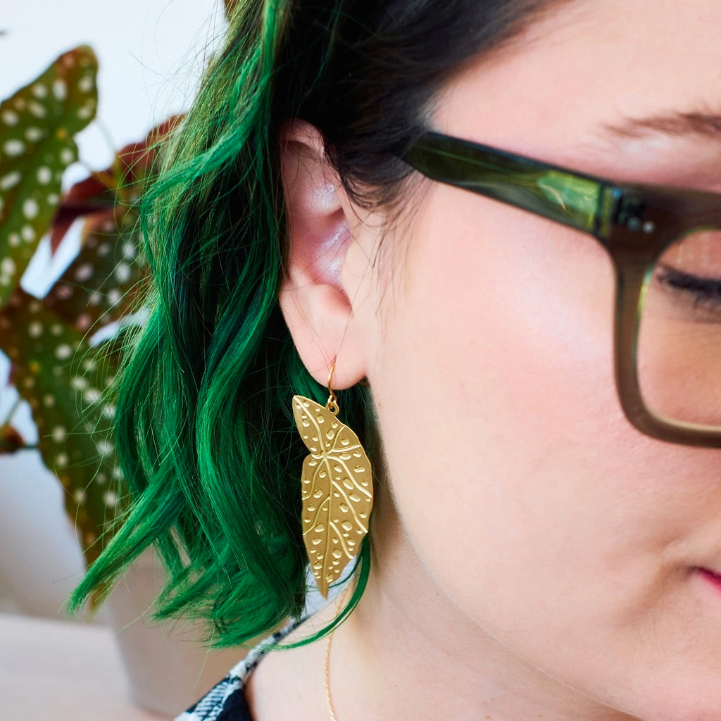 Person wearing Polka Dot Begonia Leaf Earrings Gold / Short Ear Wires.