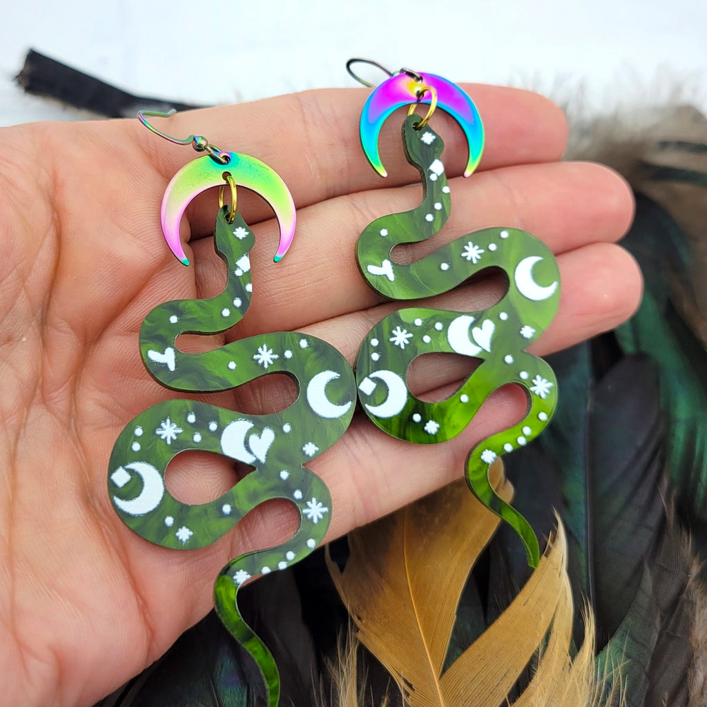 Rainbow Crescent Moon Snake Earrings Green in hand.
