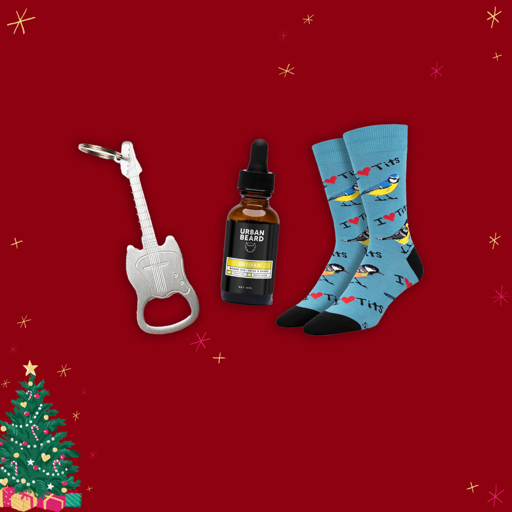 Guitar-shaped bottle opener, dropper bottle, and patterned socks on a red background with Christmas decorations.