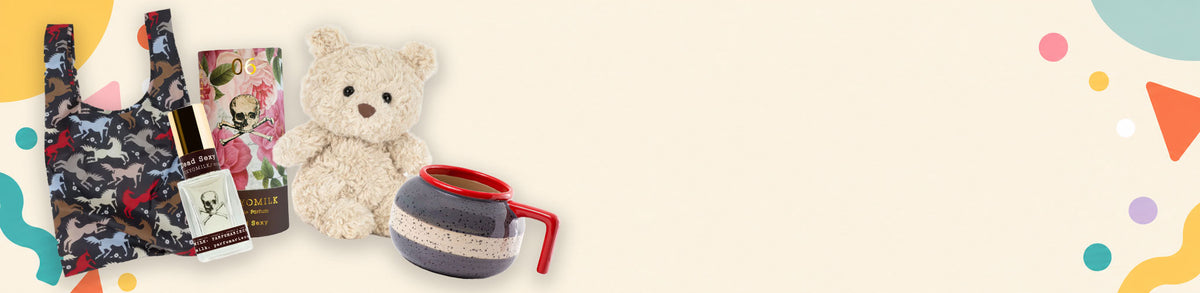 A gift bundle featuring a small beige teddy bear, a dark patterned tote bag, a small bottle, and a striped mug with a red handle, arranged on a light cream background with colorful abstract shapes on the right side.