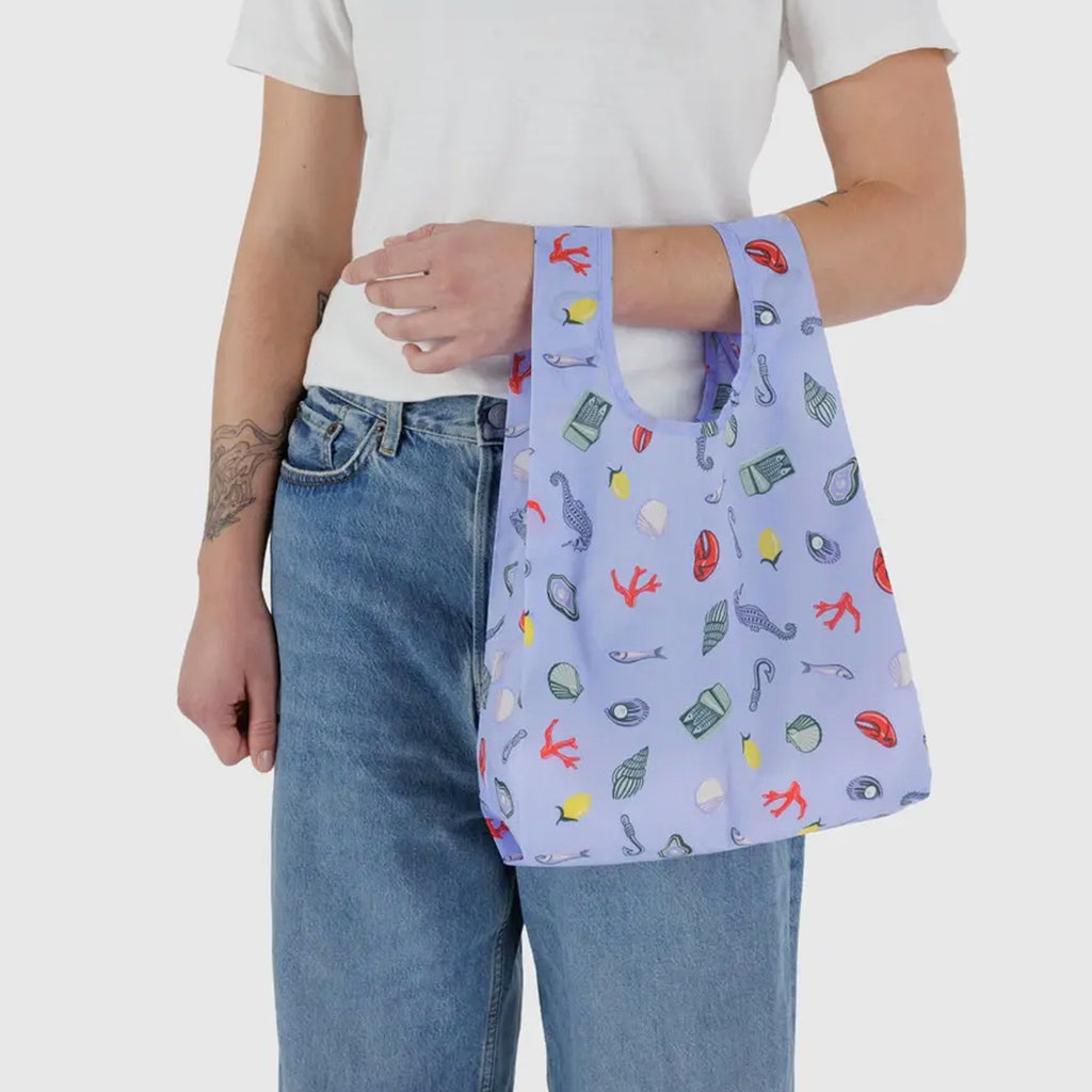 Baby Baggu Sea Charms being held.