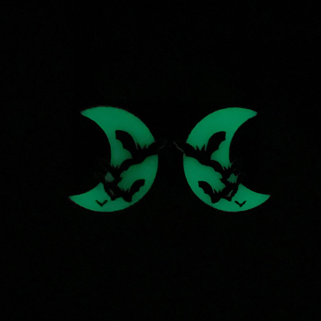 Bat's Amore Bat/Moon Earrings glowing in the dark.