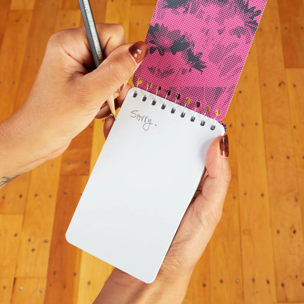 Being Rude Spiral Notebook being used.