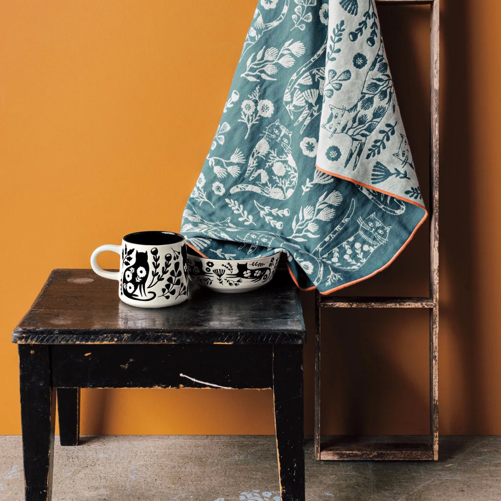 Catbloom Imprint Mug on table.