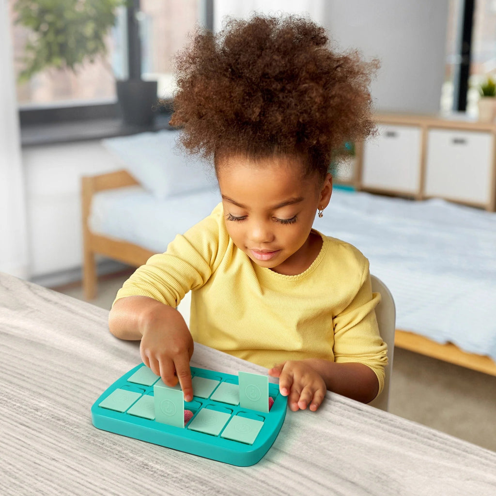 Child playing with Mini Match Up Memory Snack Tray.