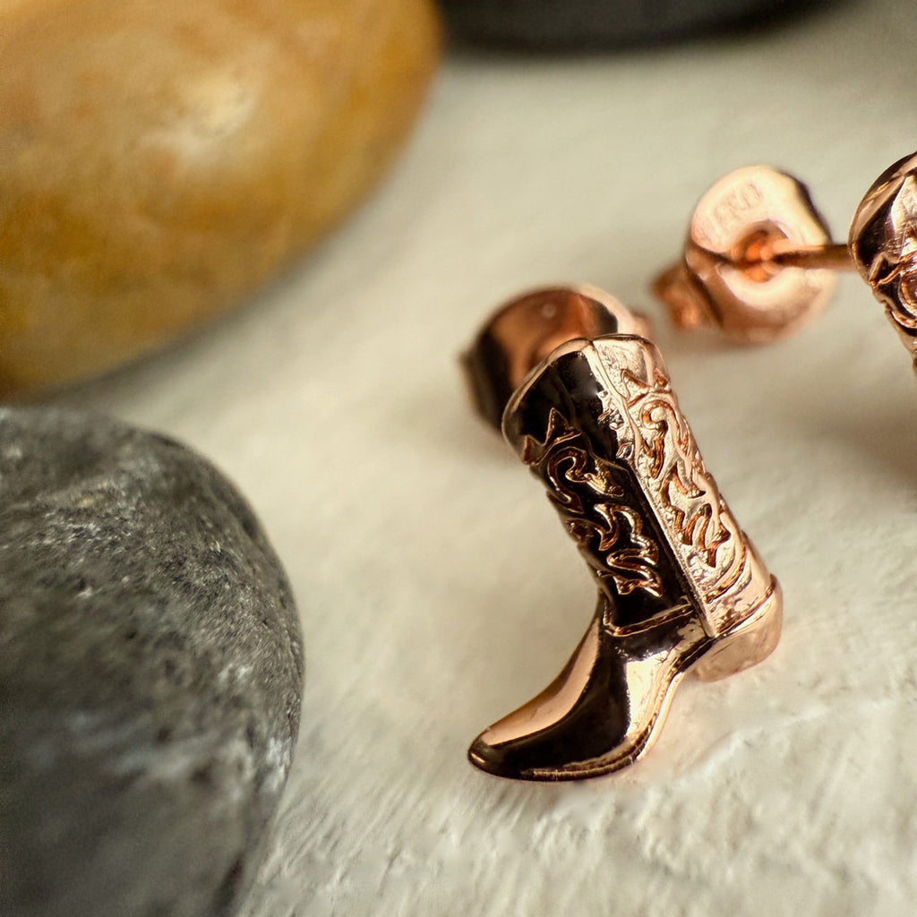 Close-up view of Cowboy Boot Stud Earrings Rose Gold.