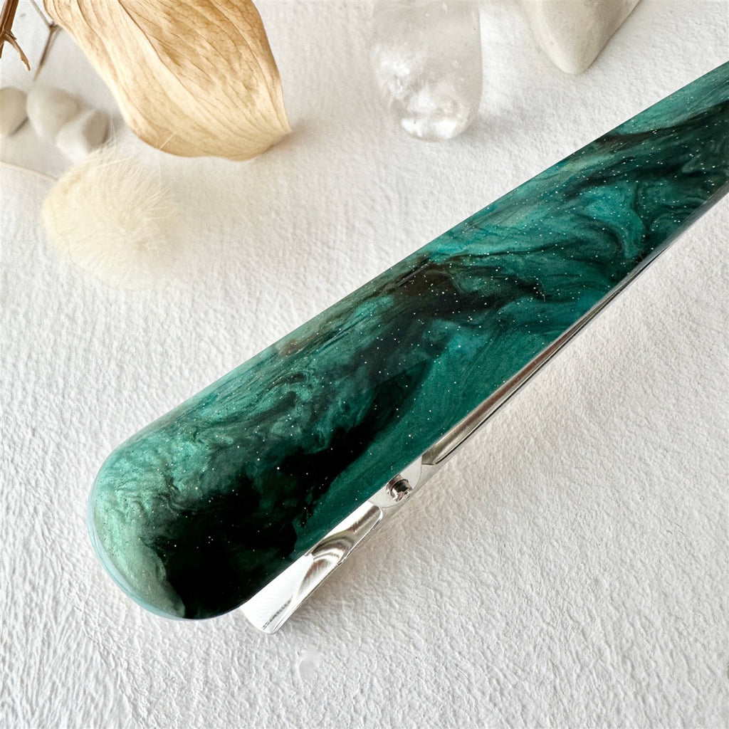 Close-up view of Extended Bird Beak Hair Clip Green Shell.