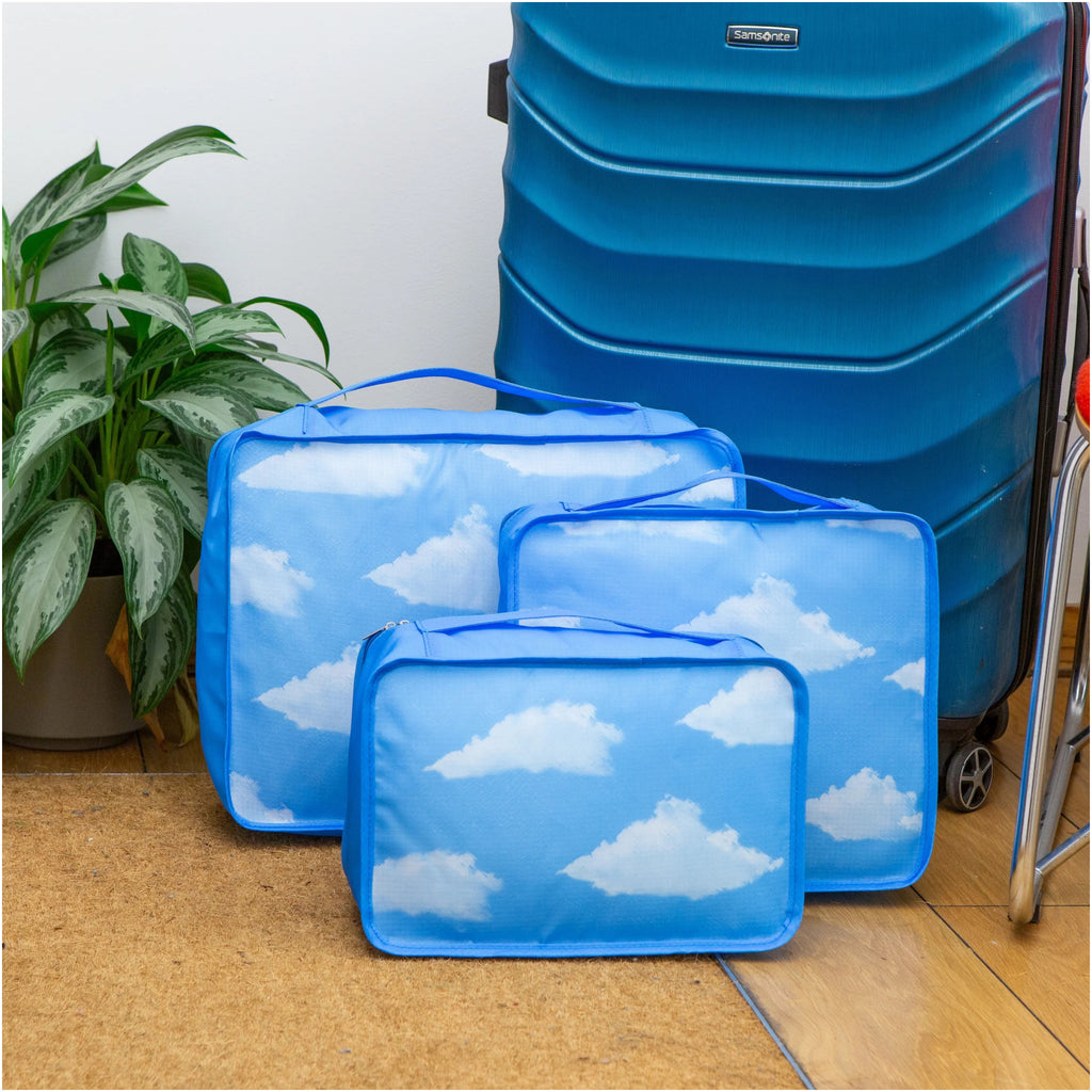 Cloud Packing Cubes on floor.