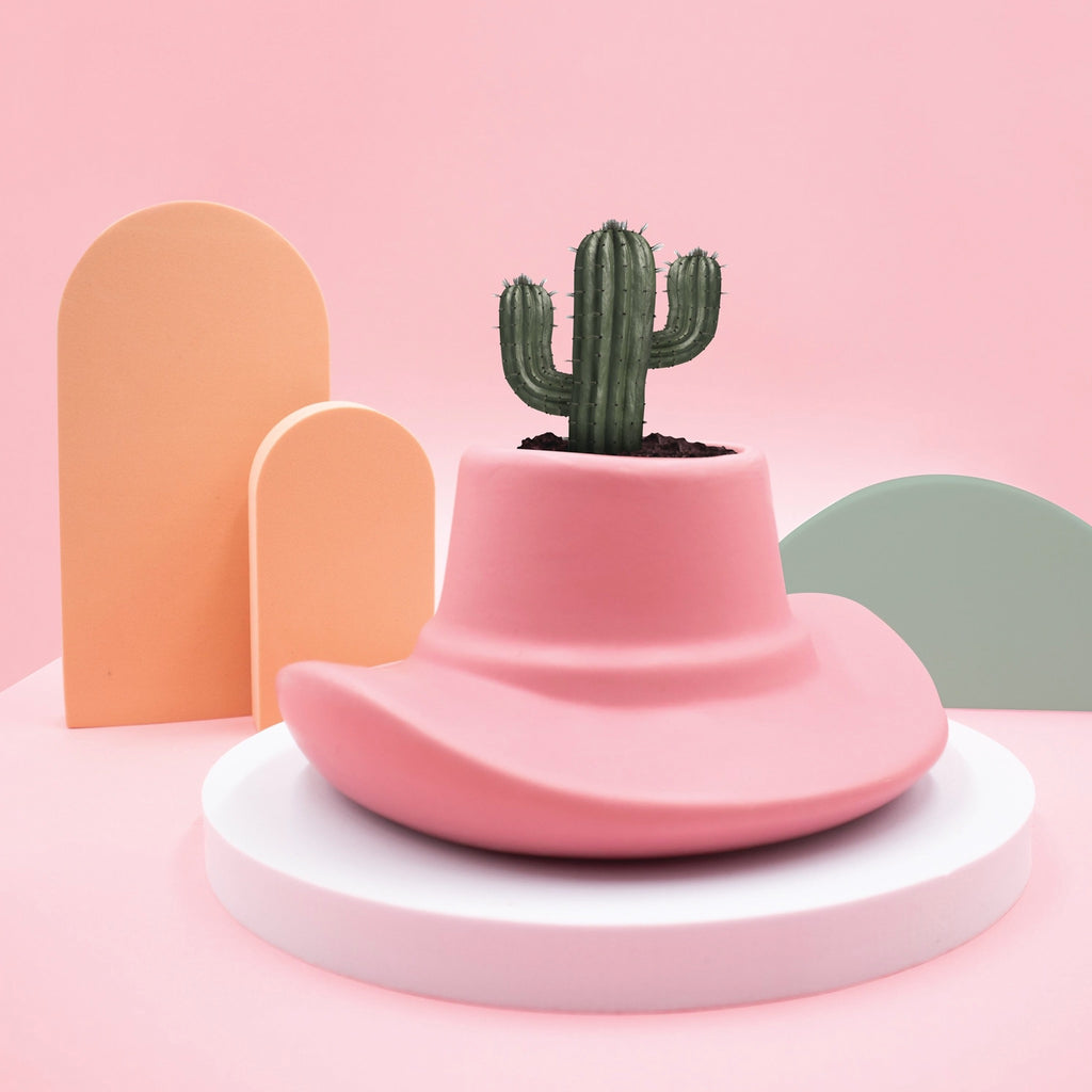 Cowboy Planter on pink surface.