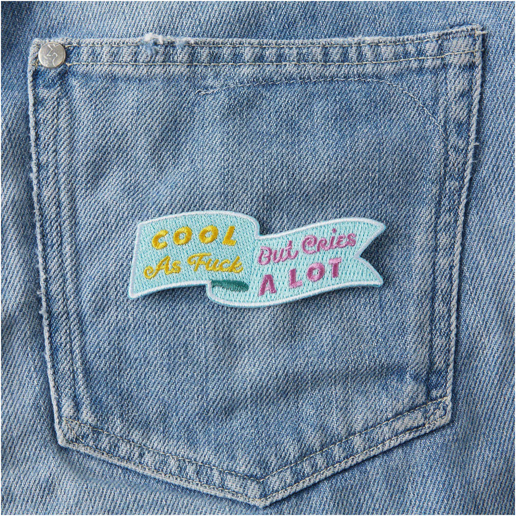 Cries A Lot Embroidered Iron On Patch on jeans.