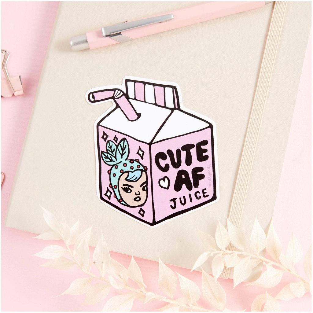 Cute AF Juice Vinyl Sticker on book.