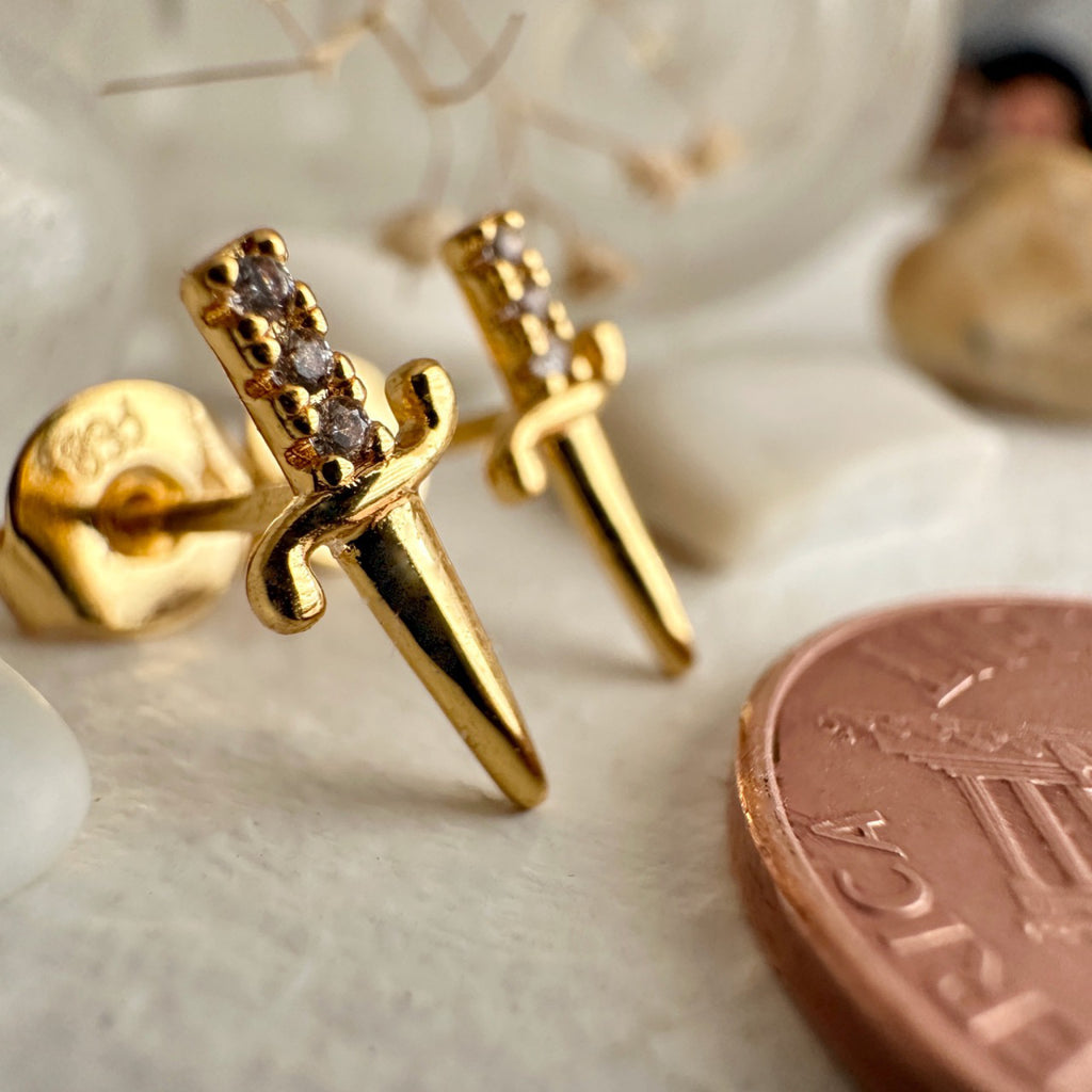 Dagger Stud Earrings Gold besides penny.