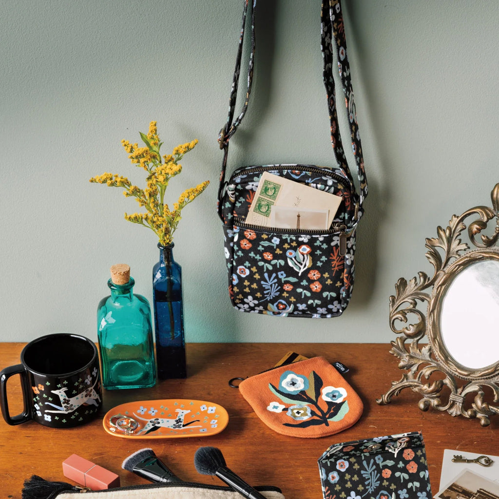 Dogwood Crossbody Bag on table.