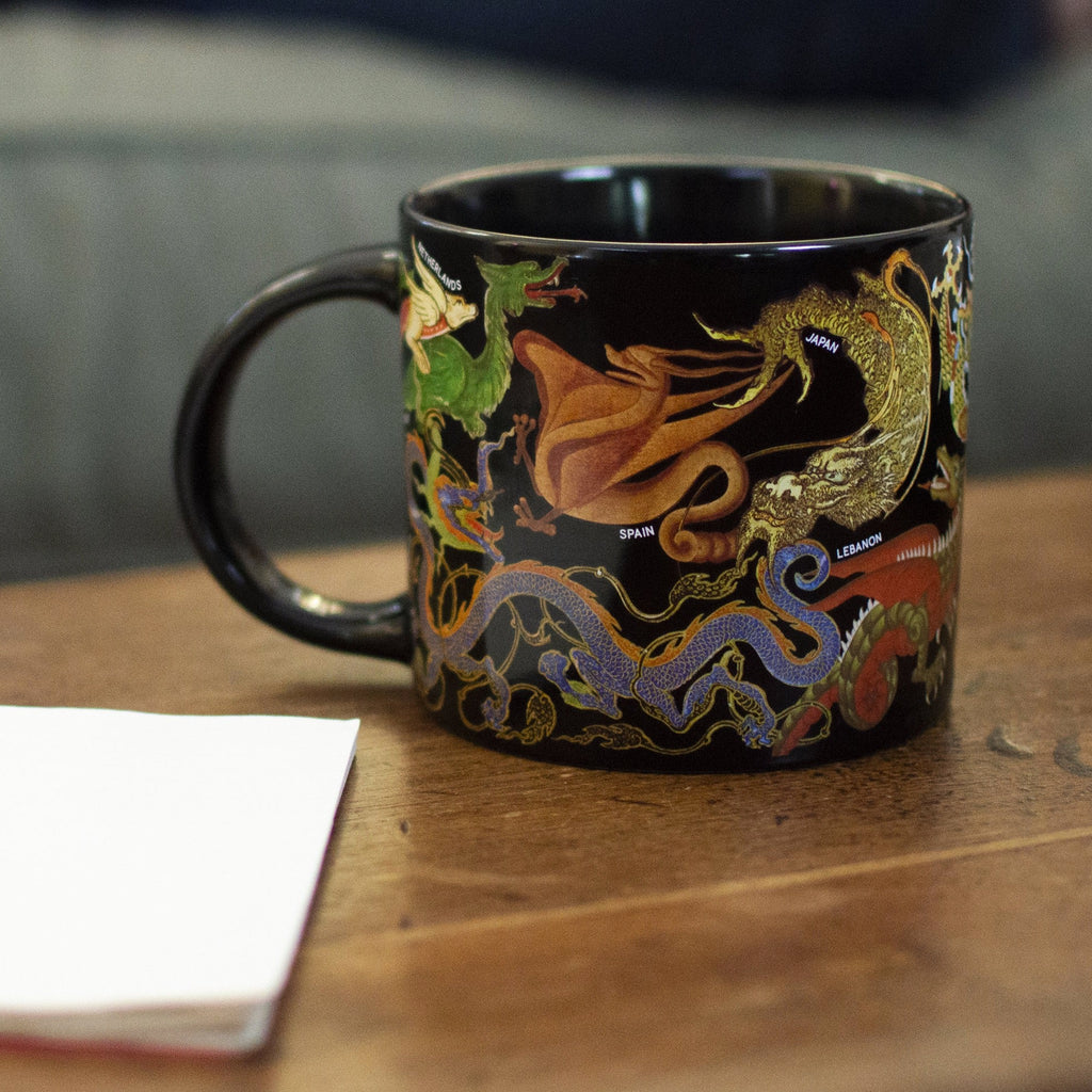 Dragons Mug on table.