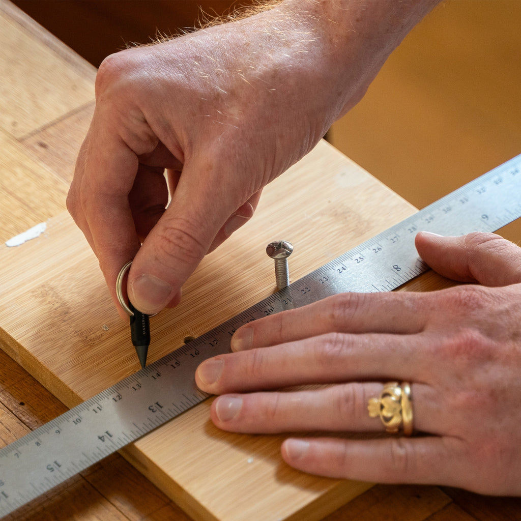 Everlasting Pencil Keychain being used with ruler.