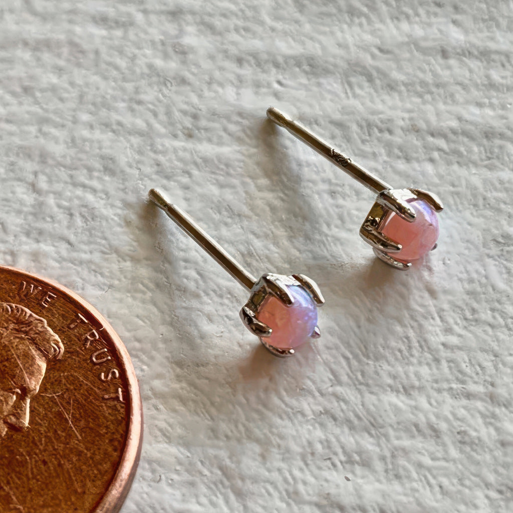 Fire Opal Stud Earrings Sterling Silver beside a penny.