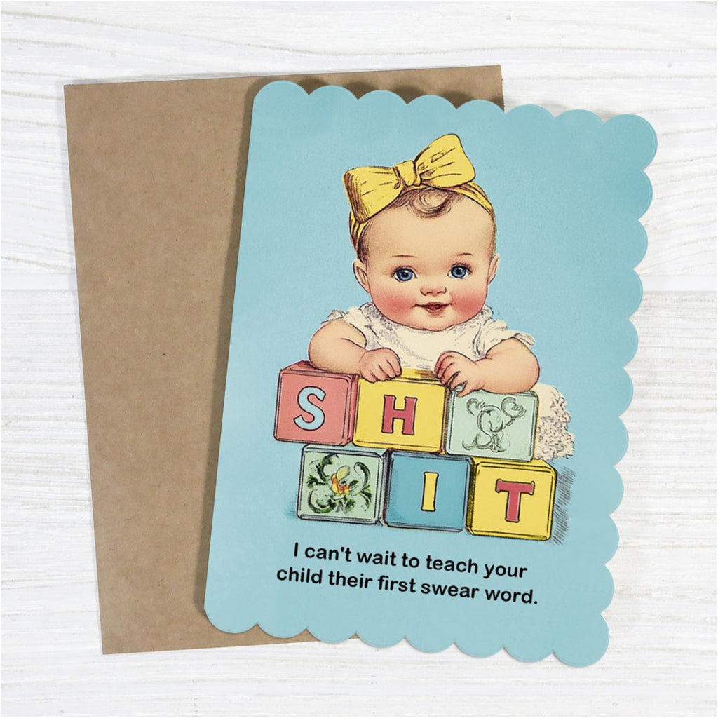 First Swear Word Baby Card on table.