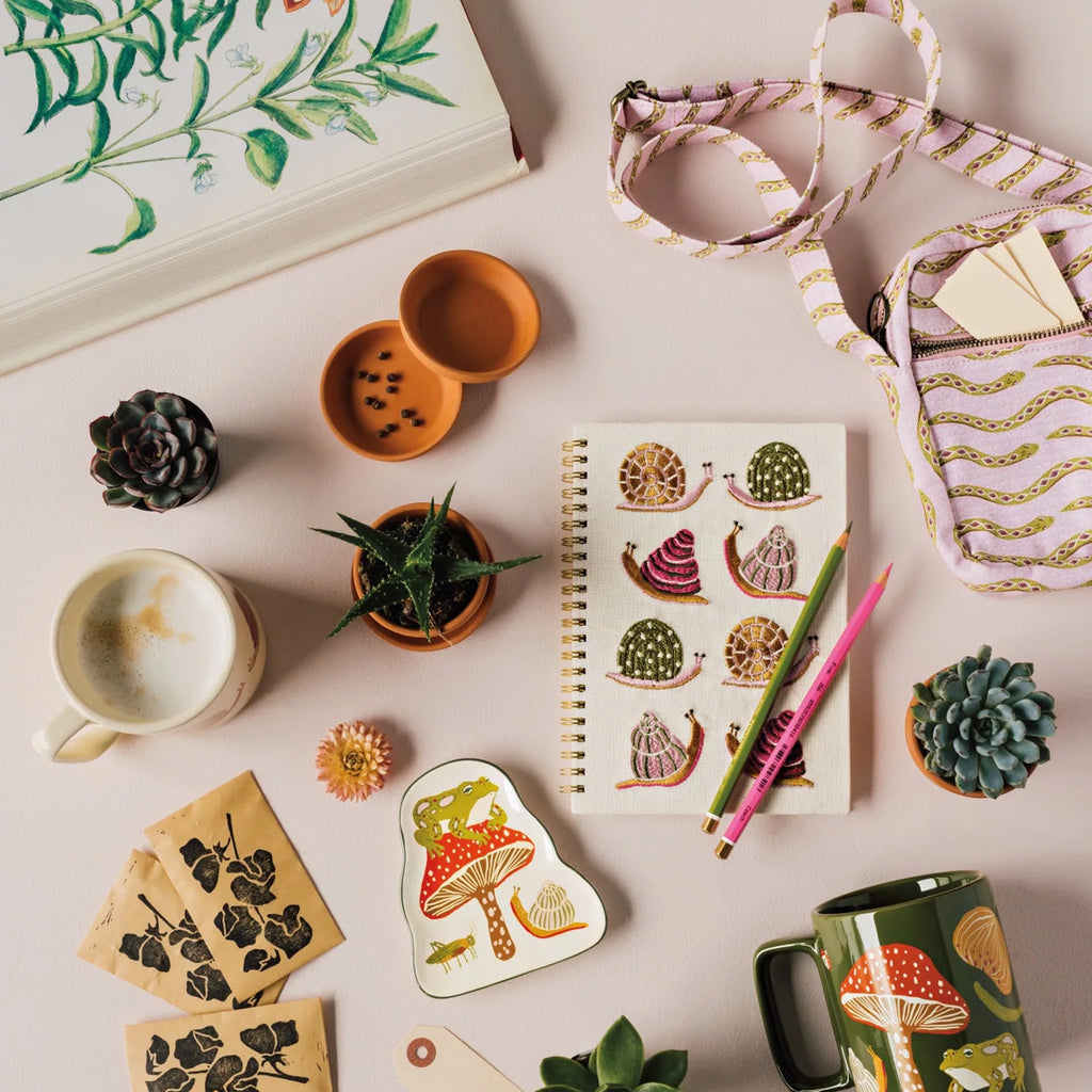 Gardenland Embroidered Notebook on table.