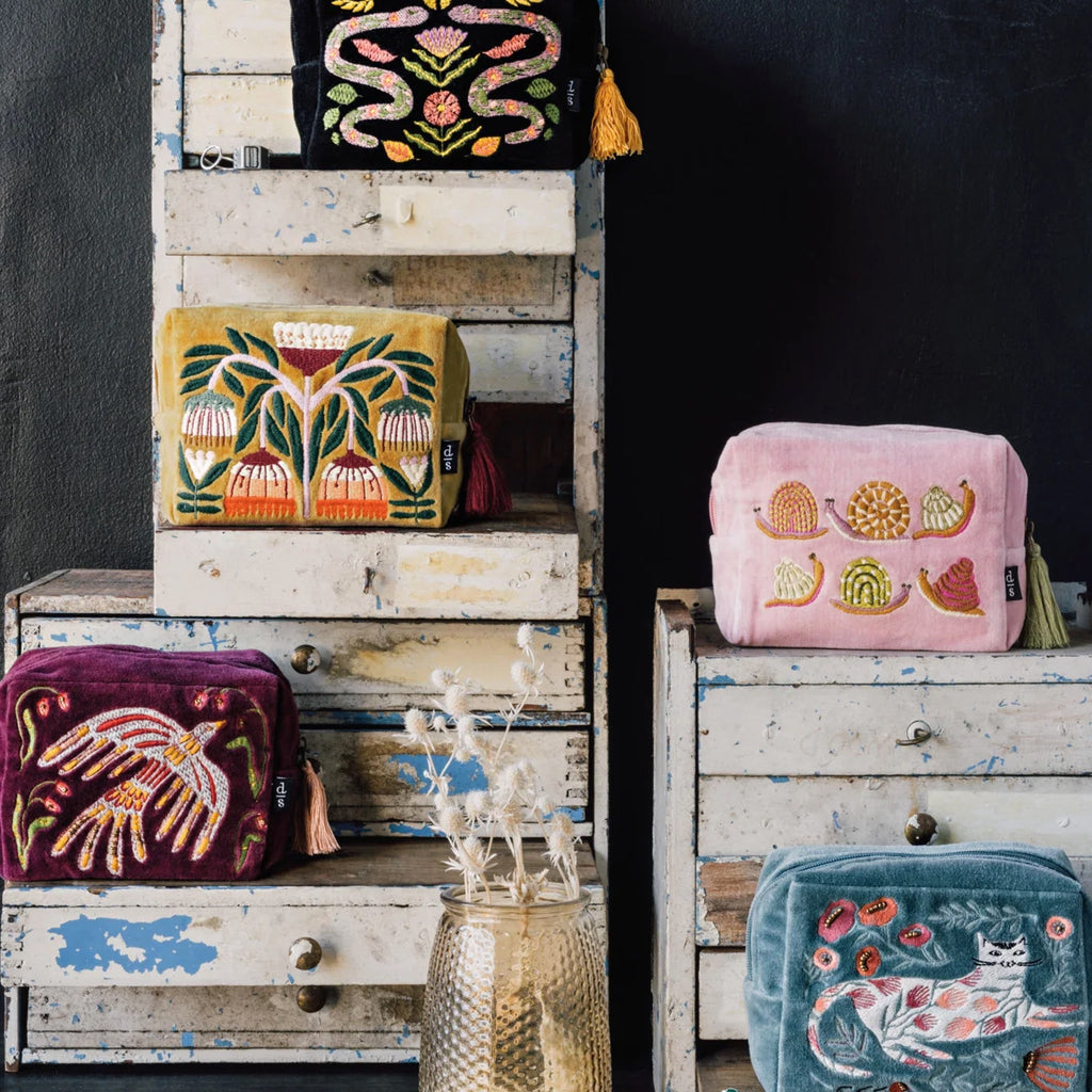 Gardenland Embroidered Pouch on dresser.