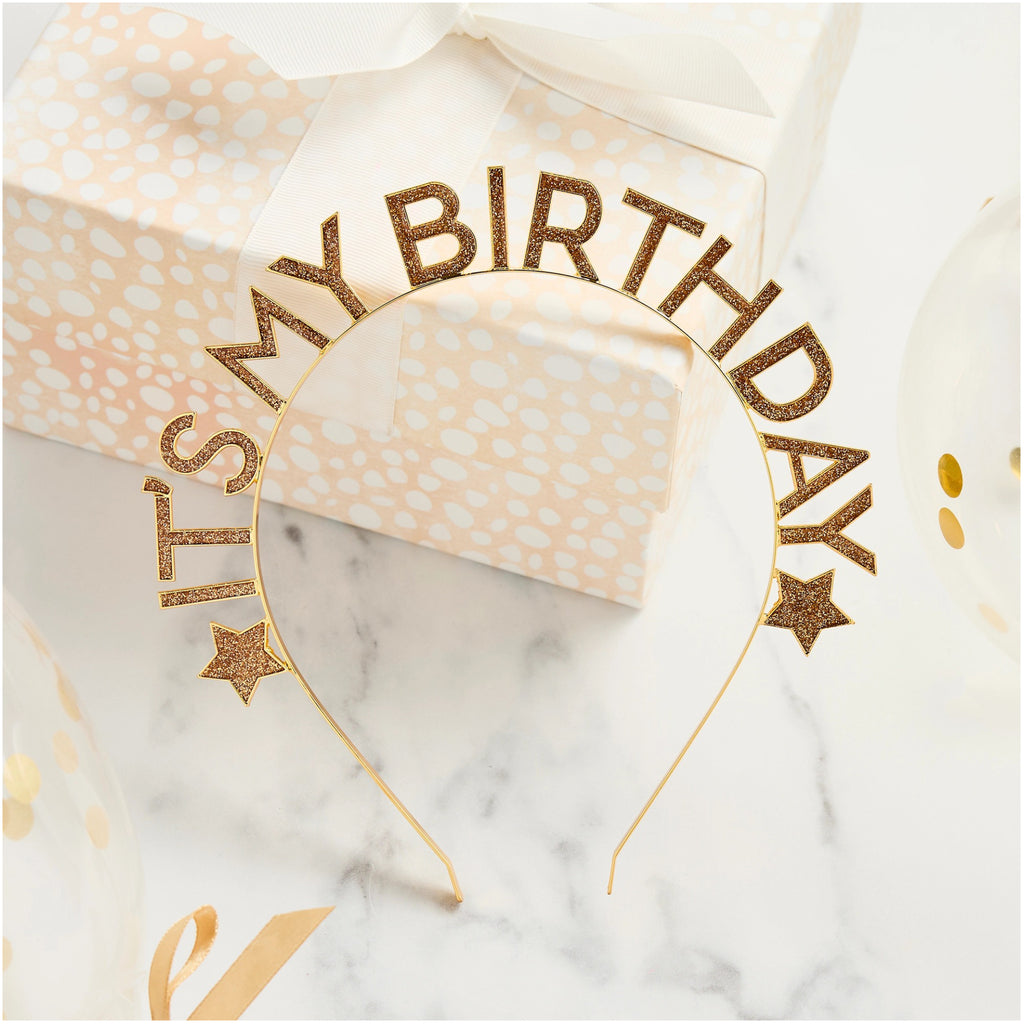 Gold 'It's My Birthday' Glitter Filled Metal Headband leaning against present.