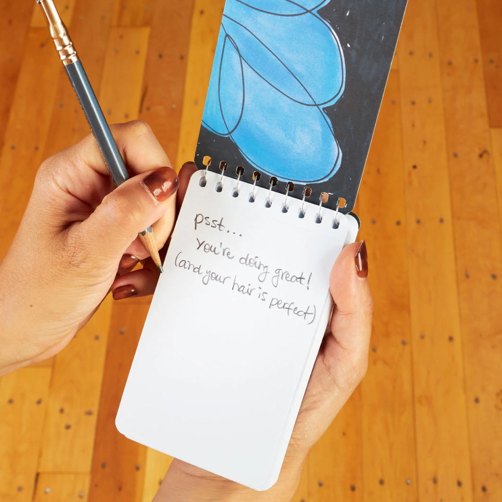 Gratitude & Shit Spiral Notebook being used.