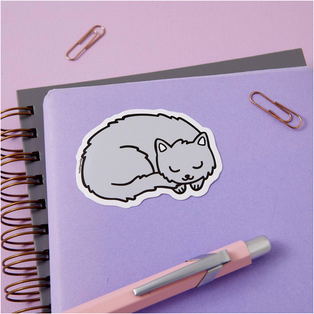 Grey Kitty Vinyl Sticker on book.