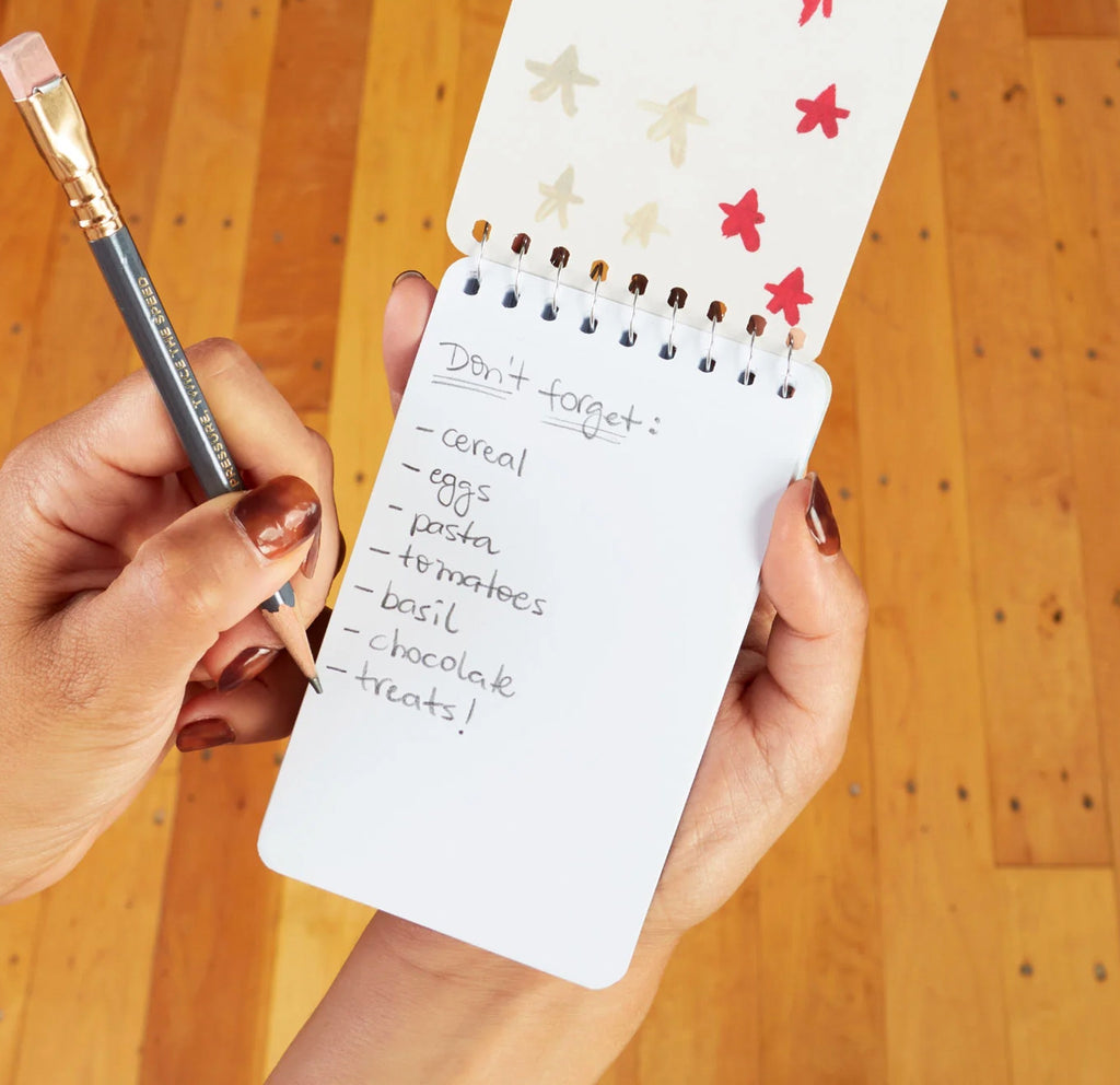 Grocery Lists Spiral Notebook being used.