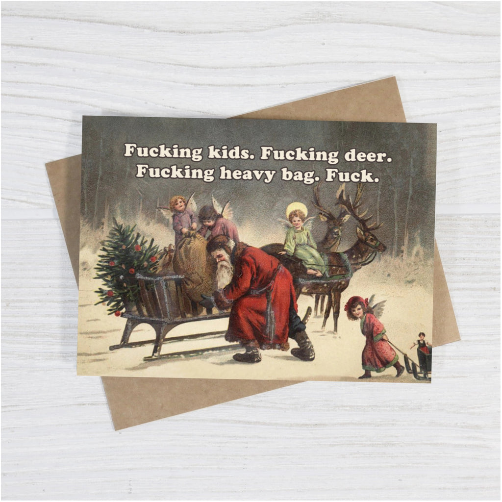 Grumpy Santa Christmas Card on table.