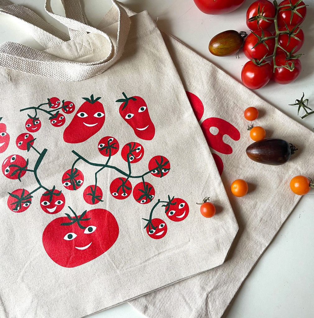 Happy Hot Tomatoes Tote Bag on table.