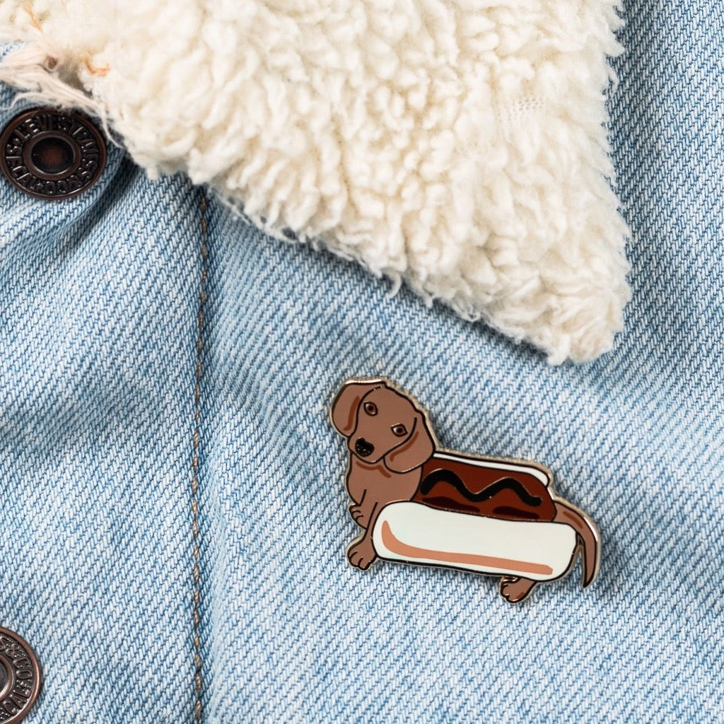Hot Dog Enamel Pin on jacket.