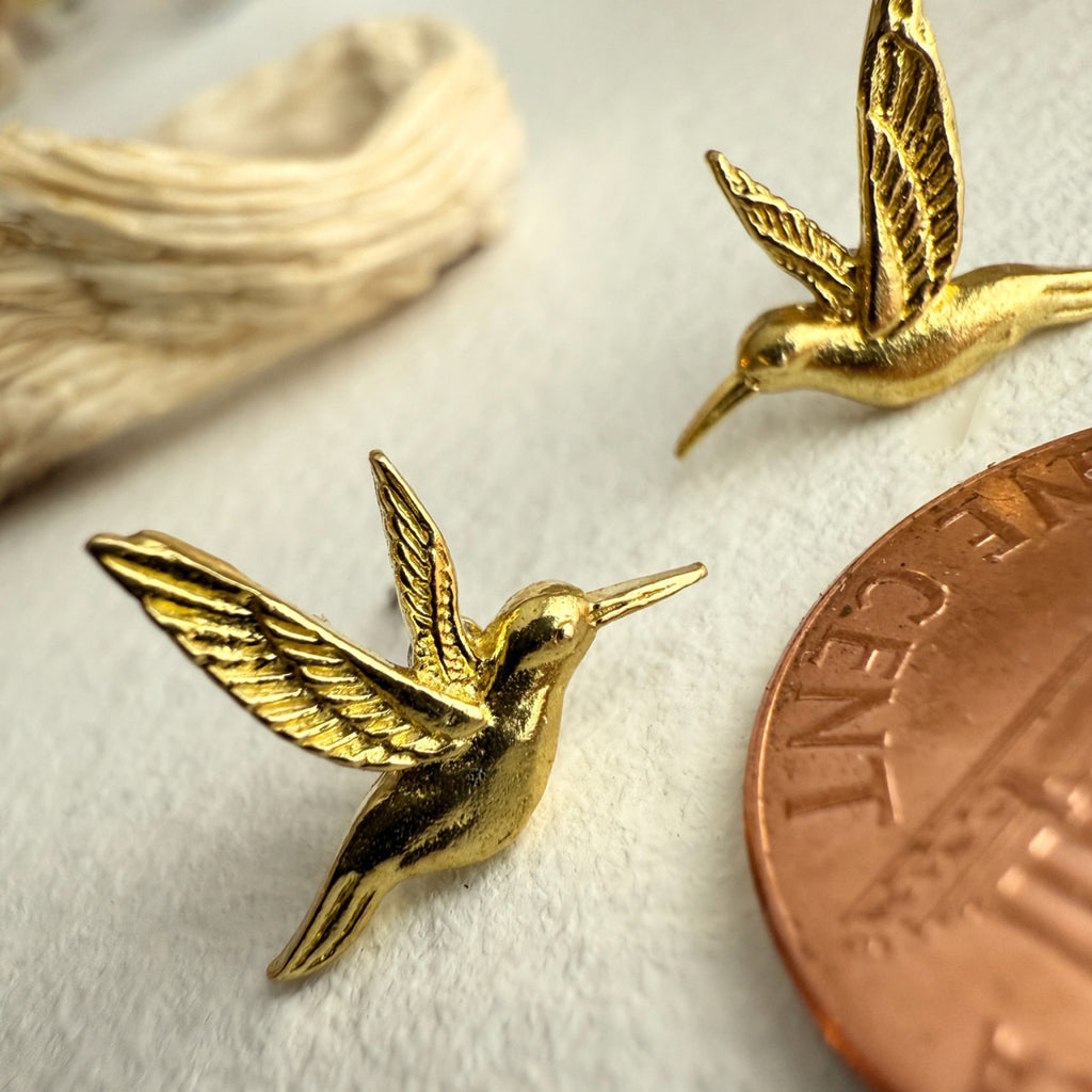 Hummingbird Stud Earrings Brass besides a penny.