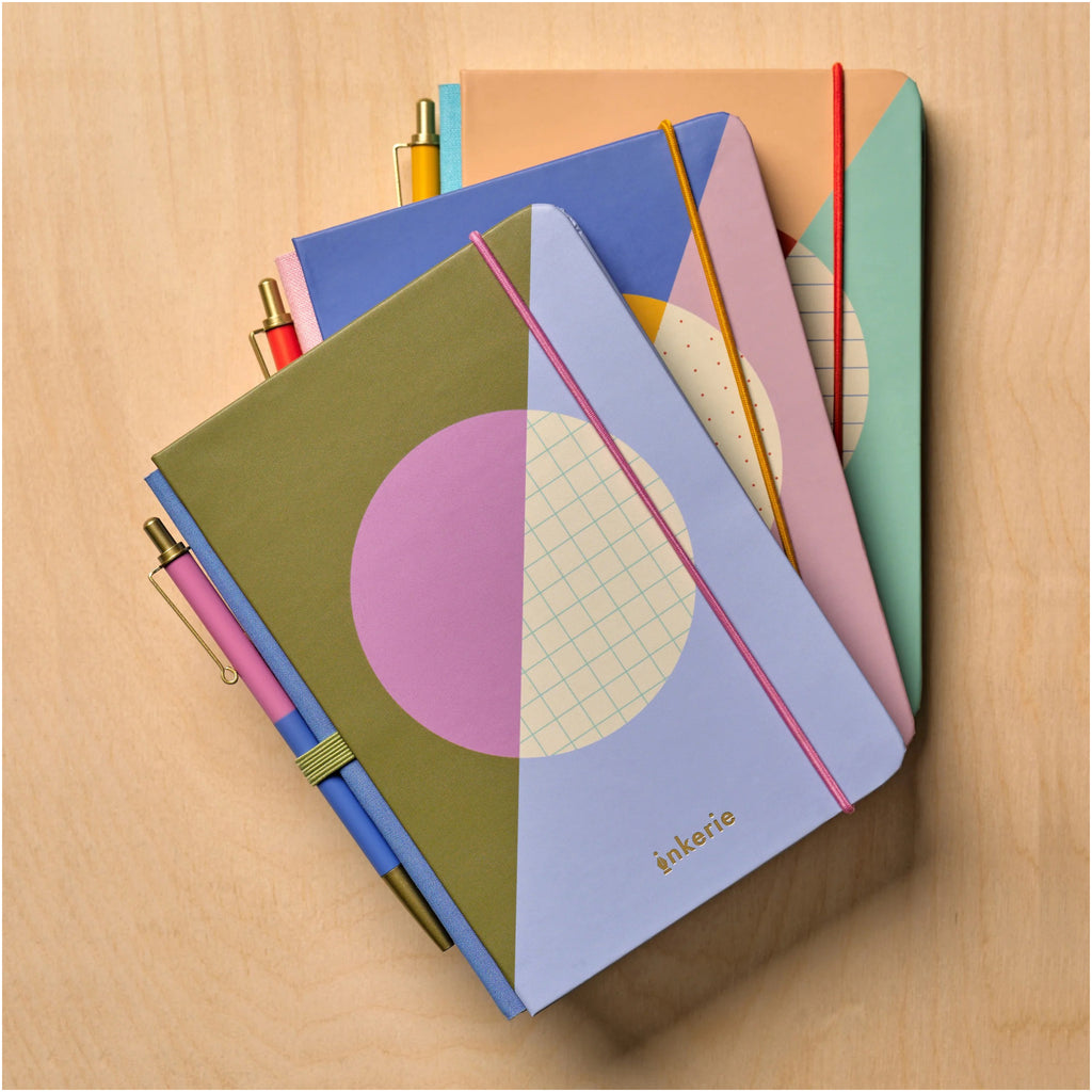 Inkerie Grid Mini Notebook & Pen on table.