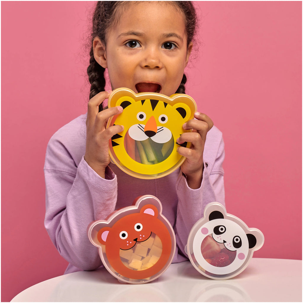 Kid playing with Kidoki On The Go Snack Boxes.