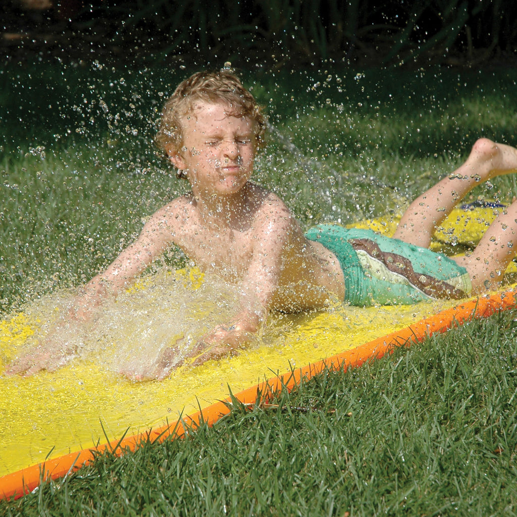 Kid playing with Slip N Slide Vintage.