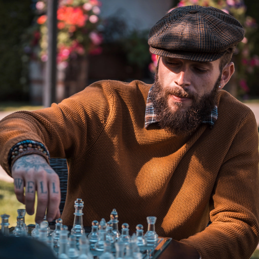 Man with beard playing chess.