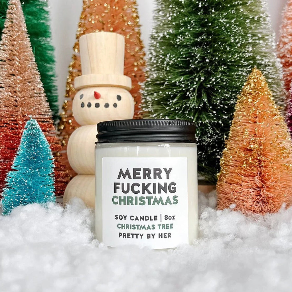 Merry Fucking Christmas Soy Wax Candle on snow.