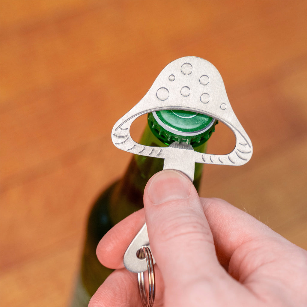 Mushroom Keychain Bottle Opener being used.