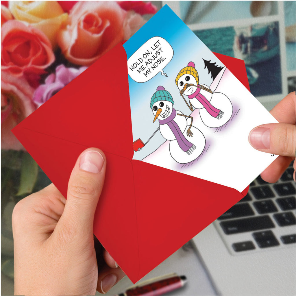 Nose Adjustment Christmas Card in hand.