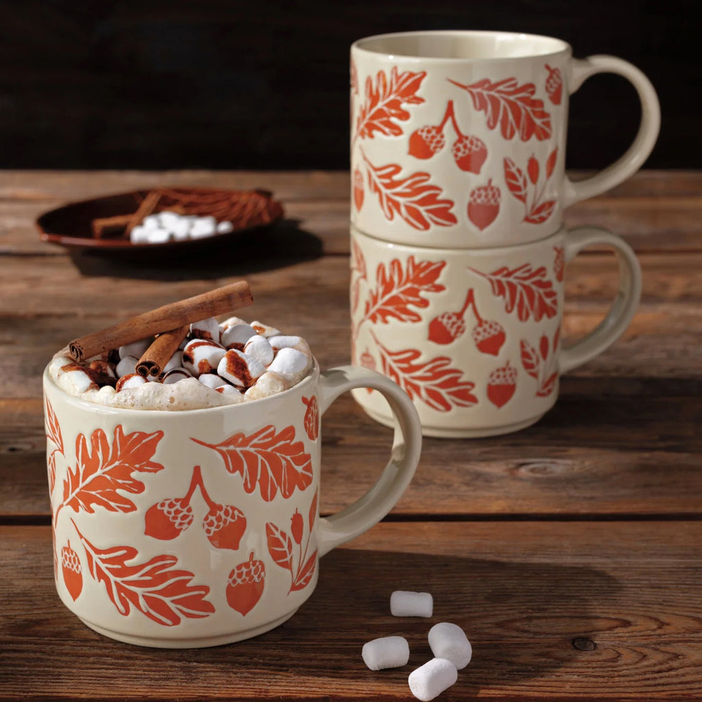 Oak and Acorn Stacking Mug on table.