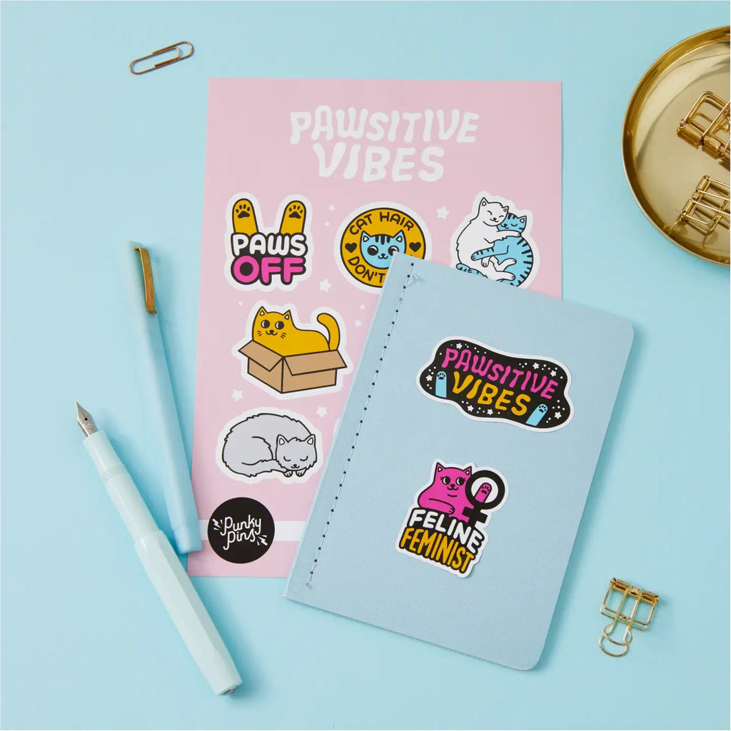 Pawsitive Vibes Cats Vinyl Sticker Sheet on book.