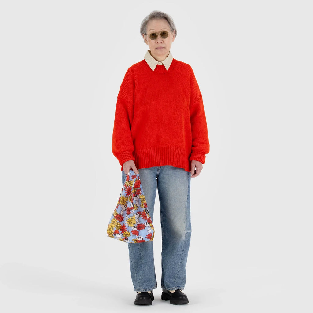 Person holding Baby Baggu Floral Snoopy.