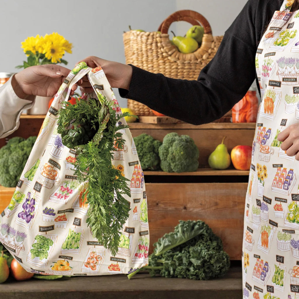 Person holding Locally Grown Grocery Bag.