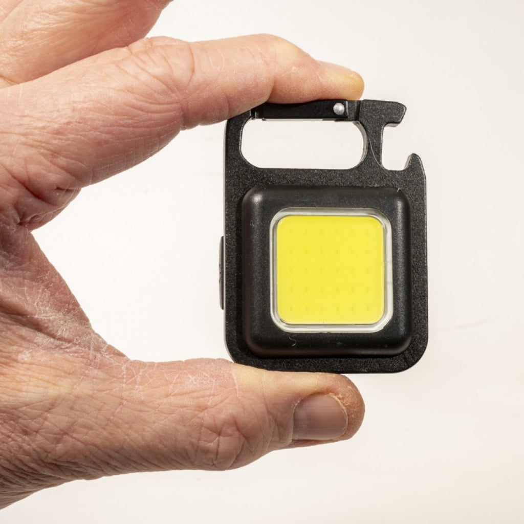 Person holding Mini Multi Light.