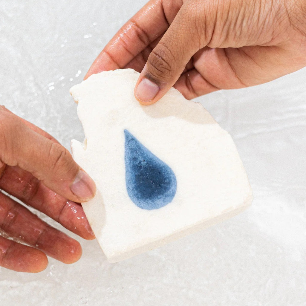 Person holding Palo Santo: Ripple Effect Bar Soap.