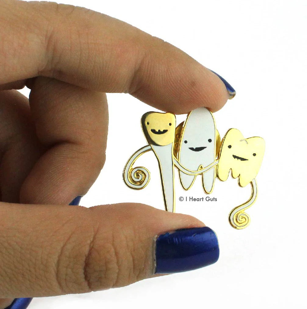 Person holding Teeth Lapel Pin.